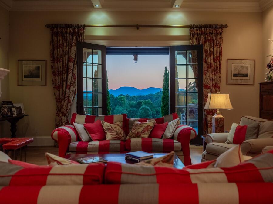 Living room at dusk with mountains through the French doors