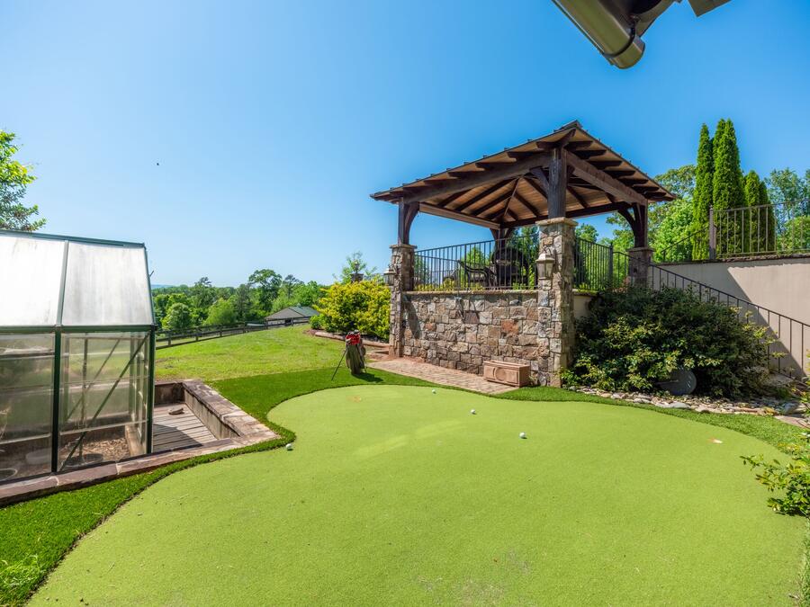 Putting green, gazebo and greenhouse